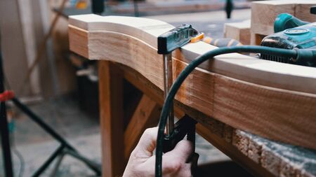 Carpentry - a man woodworker measuring the detail width