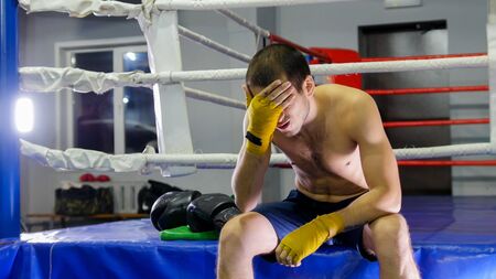 BOX - man closes his eyes with his palm - indoorの写真素材