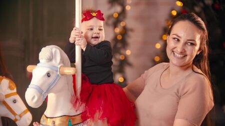 Christmas concept - a smiling woman with her baby