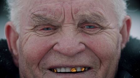 Elderly grandfather - old smiling grandfather looking in the cameraの写真素材