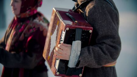 Russian folklore - russian man playing accordion outdoorsの写真素材