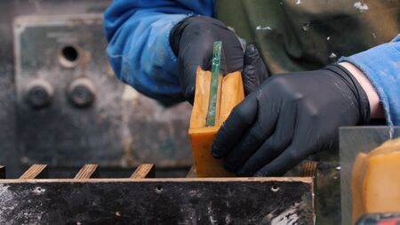 Industrial - putting a piece of glass in silicone form