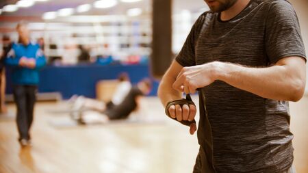 A man boxer binding his hand before the training in the gymの写真素材