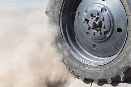 Dust and dirt comes off the tire of the truckの写真素材