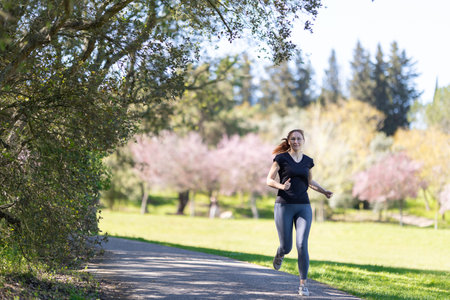 An adult woman jogging on nature