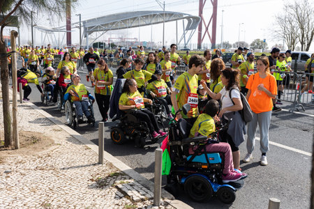 March 12, 2023 Lisbon, Portugal: people in sports clothes run a marathon - people with disability getting help at the stopのeditorial素材