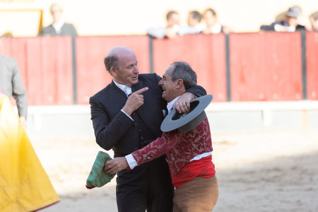 March 26, 2023 Lisbon, Portugal: Tourada - two elderly men, one of whom is a bullfighter on the arenaのeditorial素材