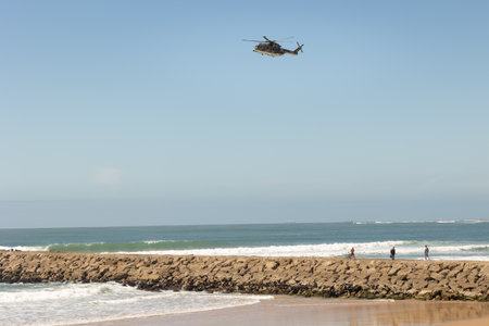 25 March 2023 Portugal, Costa da caparica: a helicopter flies over the seaのeditorial素材