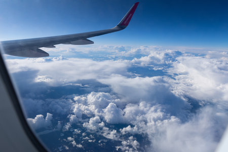 5 April 2023 Belgrade, Serbia: view from the airplane window on the wing of the aircraft and fluffy cloudsのeditorial素材