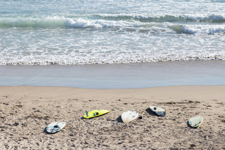 Surfboards on the beach by the seaの写真素材