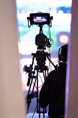 Cameraman working with TV camera shooting the gaming expo