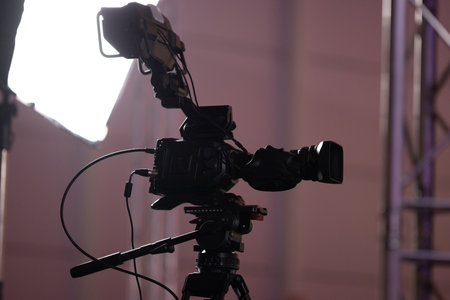 Black movie camera and light setup behind the scenes of the game exhibition