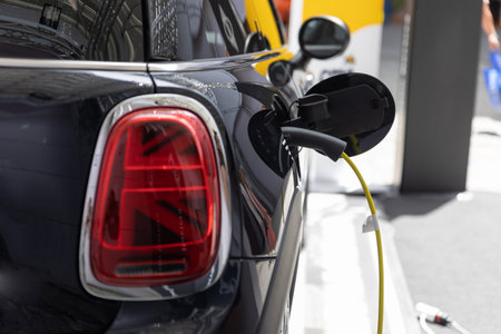 Black electro car on charge at the EV charging stationの写真素材