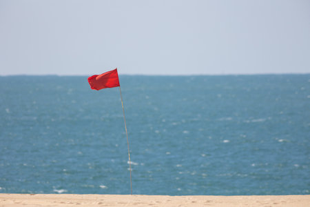 Red flag by the sea - warning signの写真素材