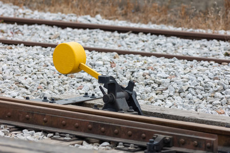 Yellow switch of railway tracks in day lightingの写真素材