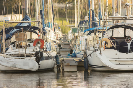 Boats moored to the pier at early sunsetの写真素材