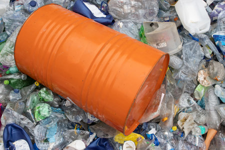 Orange barrel in a plastic garbage dumpの写真素材