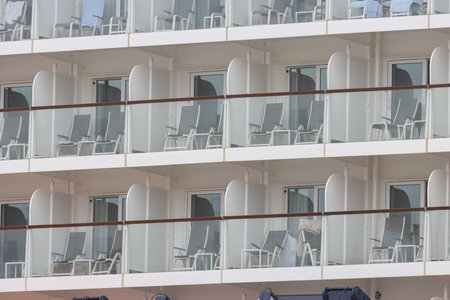 A huge tourist liner - cabin balconies and folding chairsの写真素材