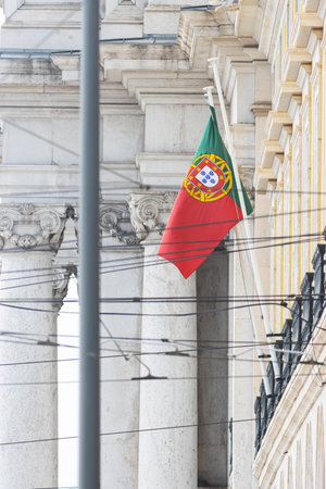 The flag of Portugal on the flagpole at the facade of the state buildingの写真素材