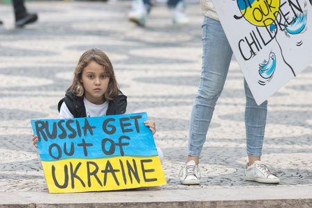 10-29-2022 LISBON, PORTUGAL: Ukrainian protest in Lisbon - little girl holds a poster in support of Ukraineのeditorial素材