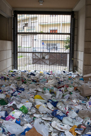16 october 2022 Almada, Portugal: plastic garbage dump behind a mesh partitionのeditorial素材