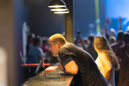 3 july 2023, Lisbon, Portugal - club Lisboa AO VIVO - concert Lyapis Trubeckoi - drunk Russian tourist is angry at the bartender at the barのeditorial素材