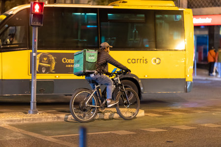 27 July 2023 Lisbon, Portugal: Food delivery uber eatsのeditorial素材