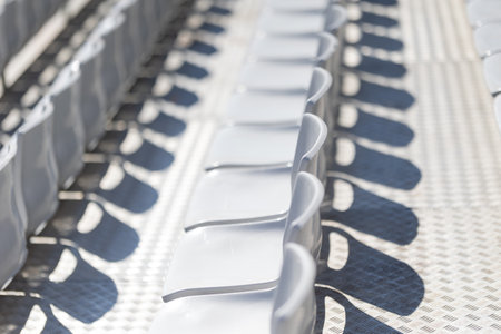 Close-up of white chairs arranged in a rowの写真素材