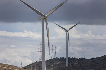 Two wind turbines, desolate terrain