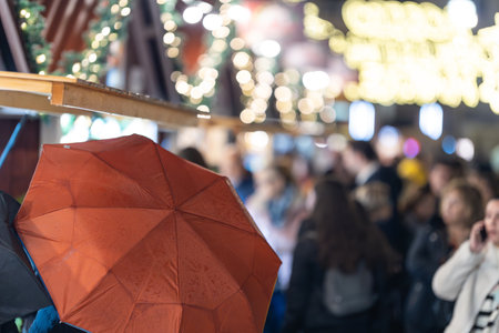 Group of People Standing Around with Umbrellasの写真素材