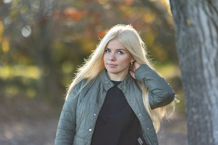 Woman Standing by Tree With Hand on Headの写真素材