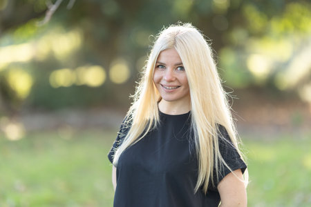 Blonde Woman with braces Standing in Field