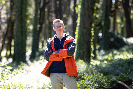 Man Standing in Woods With Arms Crossed