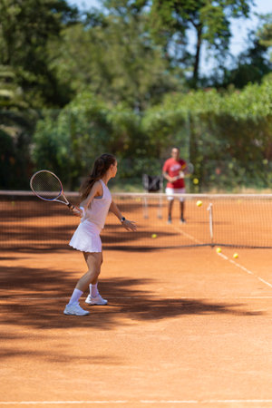 A woman is playing tennis on a clay courtの写真素材