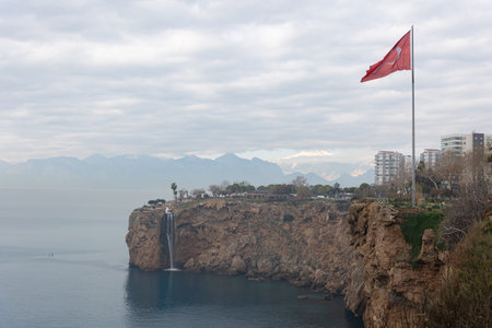 Flag of Turkey on a cliff by the sea in cloudy weatherの写真素材