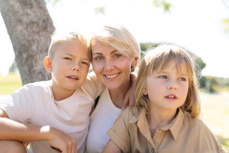 Happy mother and children enjoying outdoor time