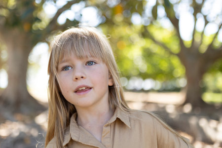 Young girl enjoying a sunny day outdoorsの写真素材