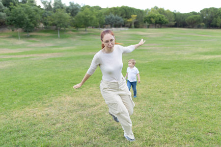 Mother and son running and playing in the parkの写真素材