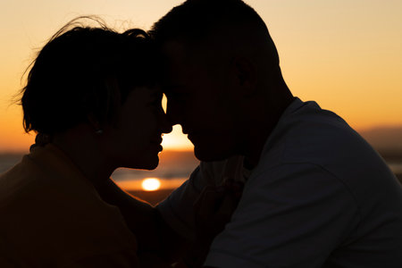 Romantic couple sharing intimate moment at sunset on beach