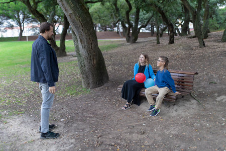 Family enjoying time together in park with balloons