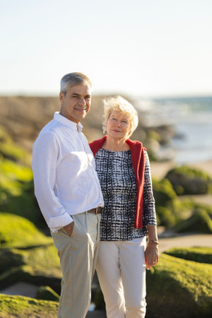Happy senior couple enjoying sunny day at the beachの写真素材