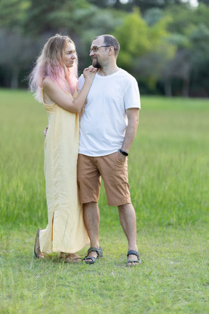 Happy couple enjoying a relaxing walk in green parkの写真素材