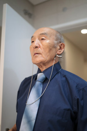 Asian senior manager leaving workplace at the end of working dayの写真素材