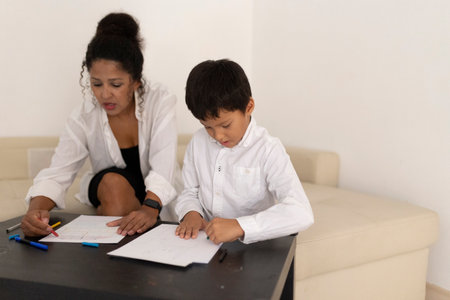 Mother and son drawing with colored pencils at homeの写真素材