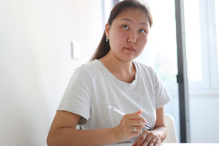 Young asian woman taking notes and brainstorming new ideas while working from homeの写真素材