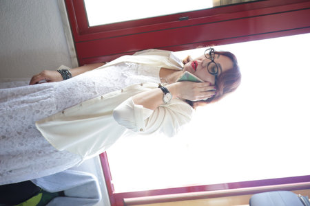 Businesswoman talking on smartphone while traveling by trainの写真素材