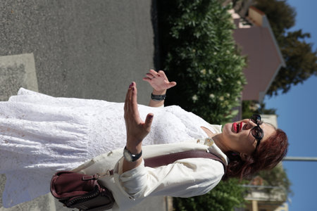 Tour guide explaining and gesturing during excursion in sunny dayの写真素材