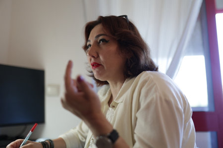 Businesswoman gesturing while talking during a meeting in the officeの写真素材