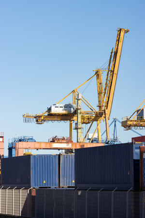 Yellow crane operates in a warehouse in the portの写真素材