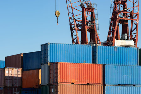 Crane is going to lift a cargo container in a seaportの写真素材